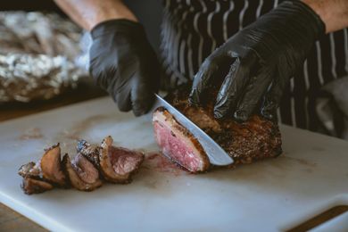 man cutting steak