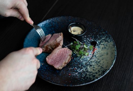 man cutting steak